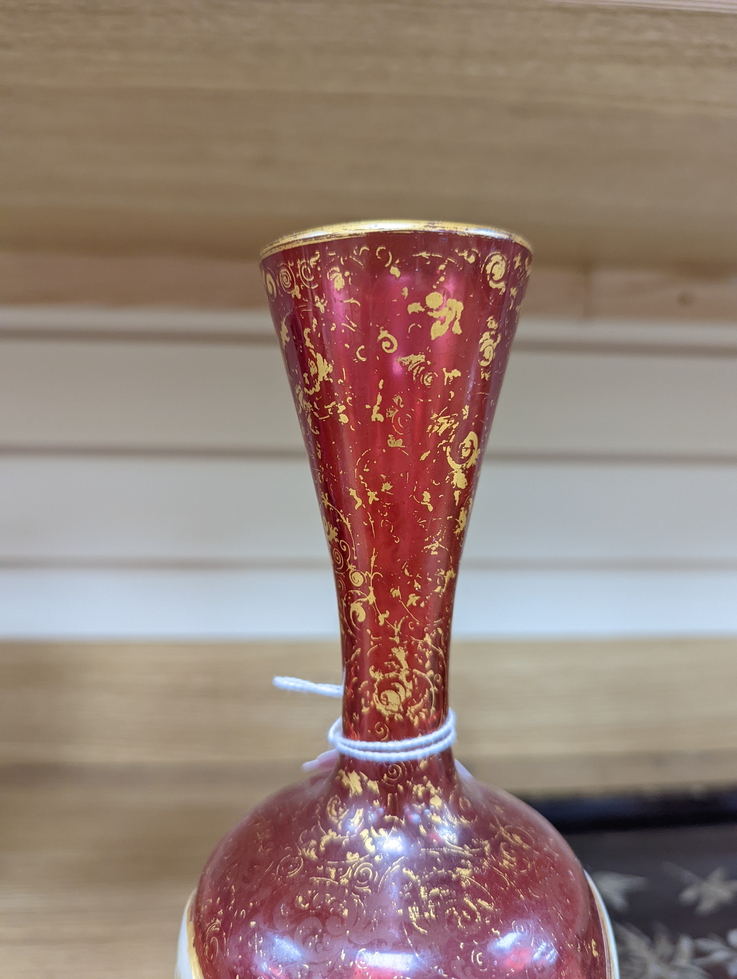 A pair of 19th century Bohemian enamelled and overlaid ruby glass vases 36cm